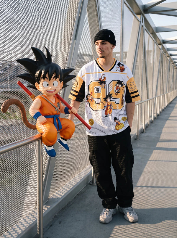 Man wearing the Son Goku white and orange anime football jersey